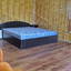 Двуспальная кровать в номере гостевой дом Адажио на косе Пересыпь в Кирилловке
