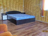двуспальная кровать в номере гостевой дом Адажио в Кирилловке