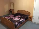 Двуспальная кровать в номере гостинный дом Курортный дворик в Степке